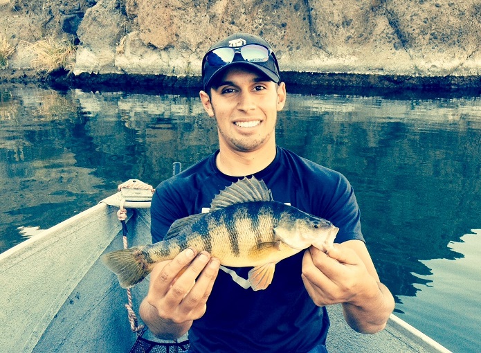 Jordan Rodriguez holding a yellow perch