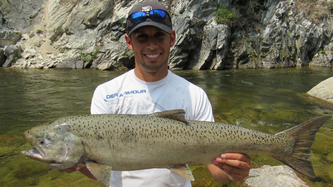 Jordan Rodriguez holding a large Chinook salmon