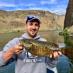 A happy customer shows off a large smallmouth bass