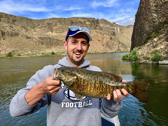 A happy customer shows off a large smallmouth bass