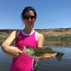 Happy female student holding a largemouth bass