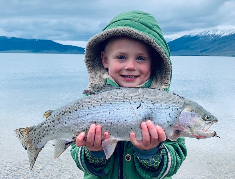 Young boy holding a large cutthroat trout at Henry's Lake in Idaho