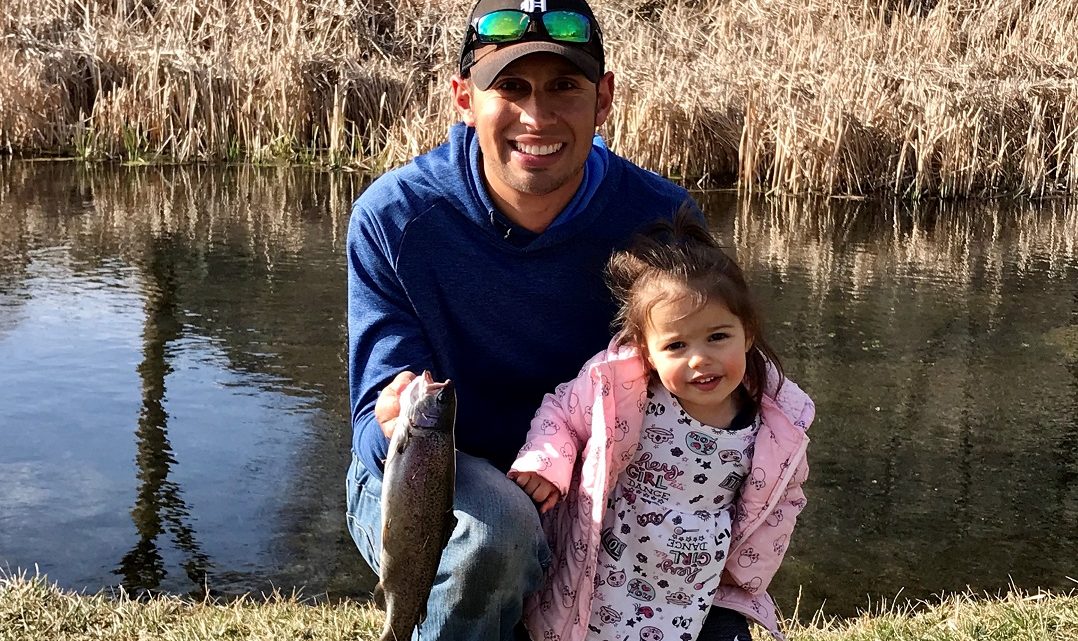Jordan Rodriguez and his daughter Quinn show off a rainbow trout caught in Hagerman