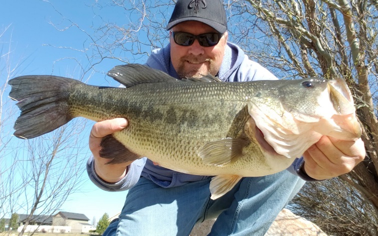 Angler Jon Urban takes a selfie with a huge largemouth bass