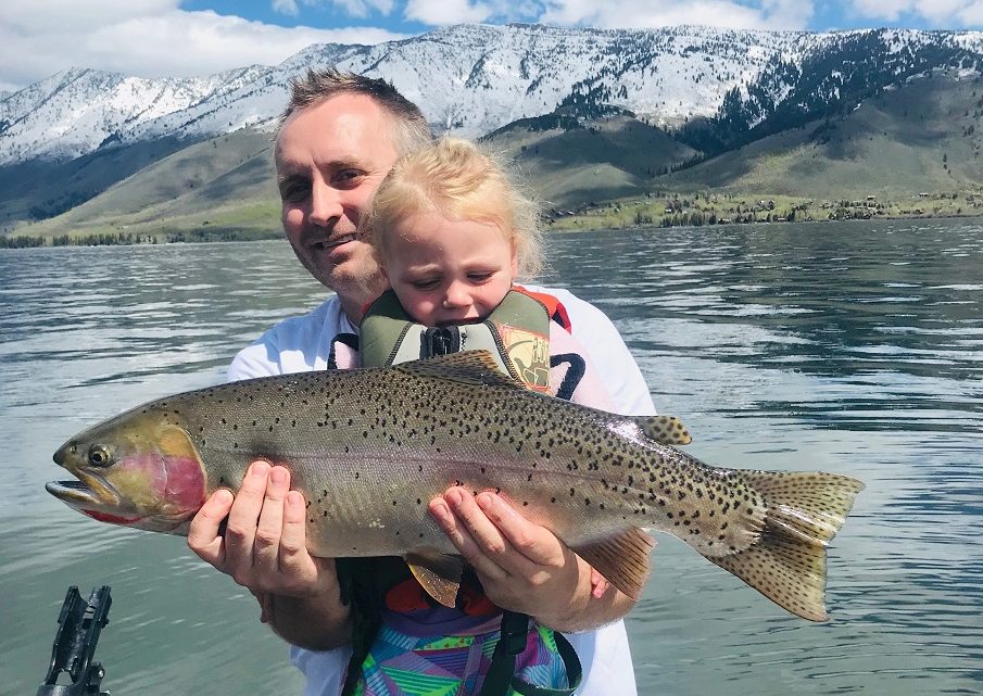 Skyler Shippen and his young daughter Joslyn show off a large cutthroat trout caught at Henry's Lake in eastern Idaho.