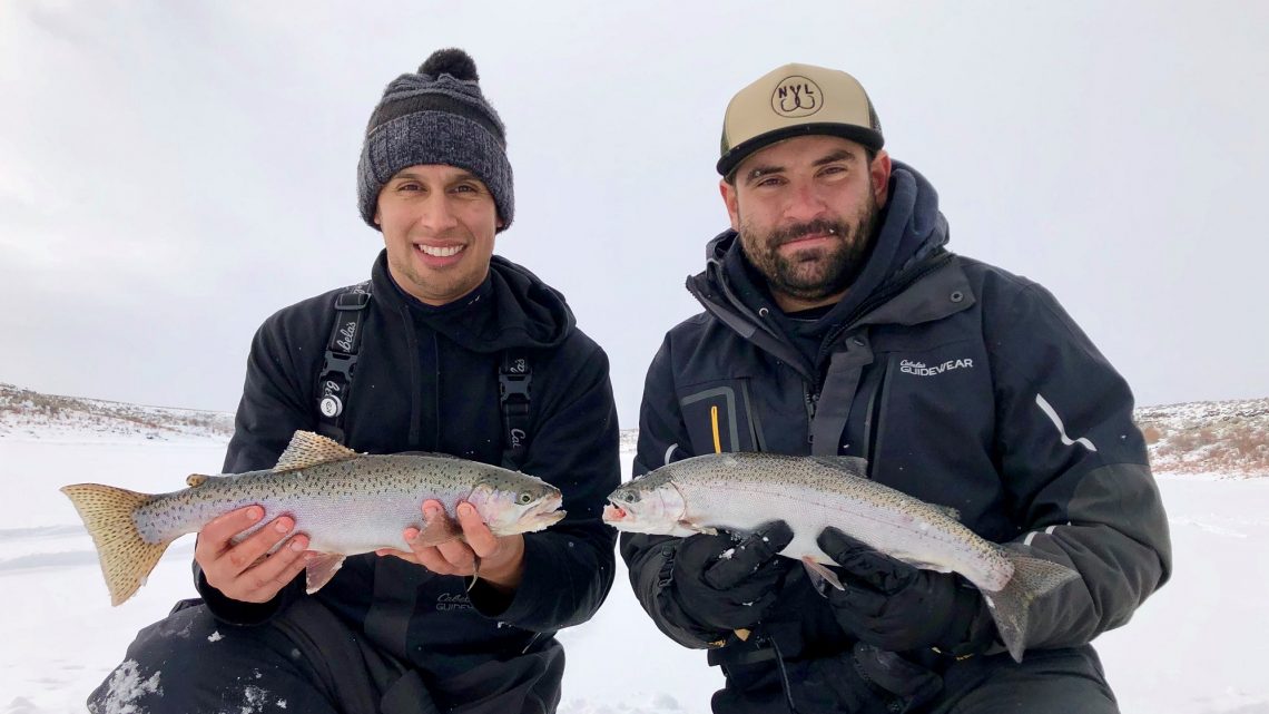 Jordan Rodriguez and Caleb Nichols hold large rainbow trout caught through the ice at Magic Reservoir