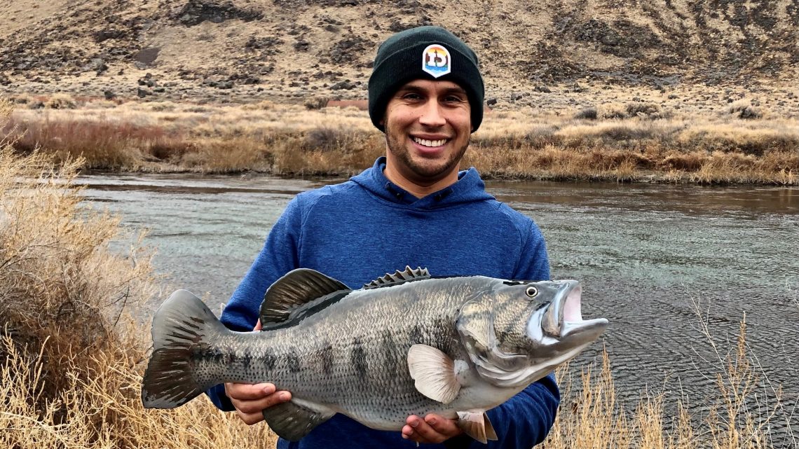 Jordan Rodriguez shows off a replica mount of a 24-inch largemouth bass.