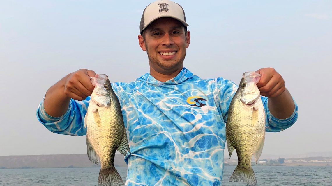 Jordan Rodriguez shows off two large crappies he caught at C.J. Strike Reservoir