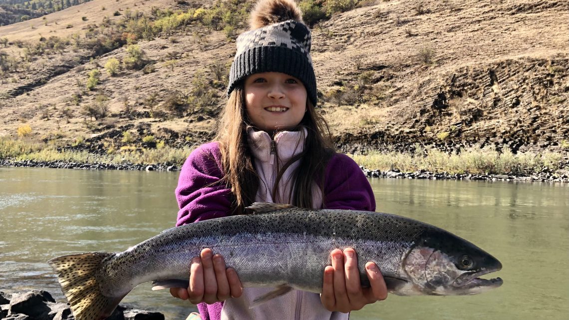 Cora Schmidt shows off a nice steelhead she caught in the Salmon River