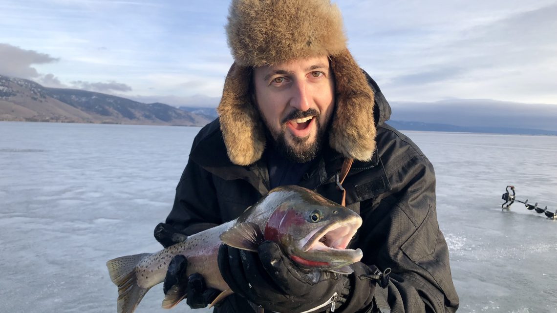 Justin Dalme shows of a large cutthroat trout caught through the ice at Henrys Lake