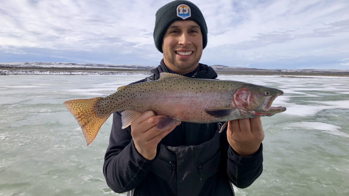 Jordan Rodriguez shows off a nice cutthroat trout caught through the ice