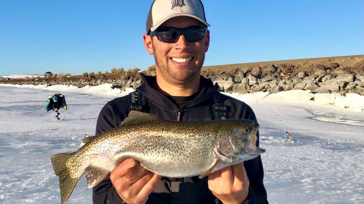 Jordan Rodriguez with a large rainbow trout caught through the ice at Mountain View Lake