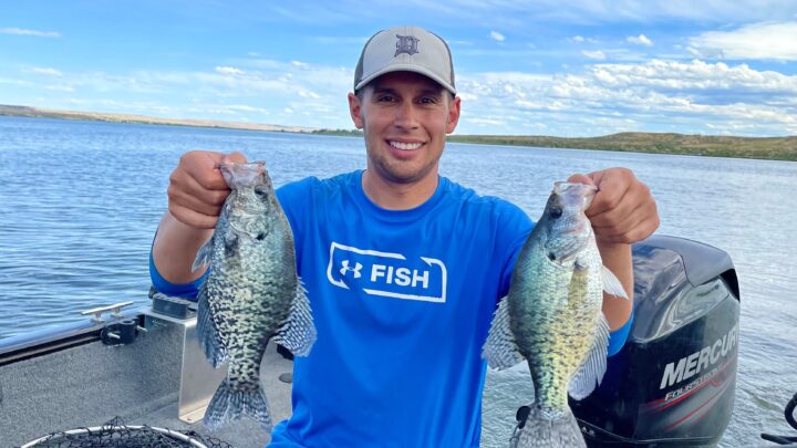 Jordan Rodriguez holds two large crappie caught at C.J. Strike Reservoir