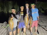 Jordan Rodriguez, Captain Tim Parrish of Hammett Valley Fishing Adventures and friends show off the haul of a night bowfishing on the Snake River