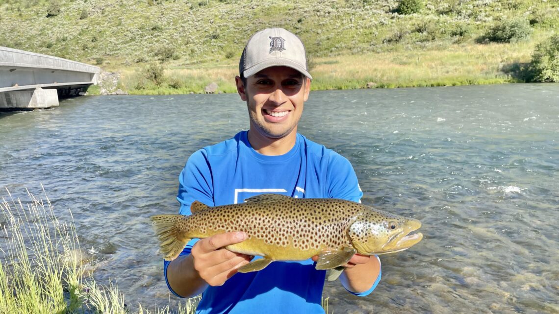 Jordan Rodriguez holds a nice brown trout caught on the Henrys Fork of the Snake River