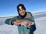 Jordan Rodriguez with a 22-inch cutthroat trout caught through the ice.