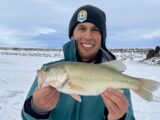 Jordan Rodriguez with an 18-inch largemouth bass caught through the ice.