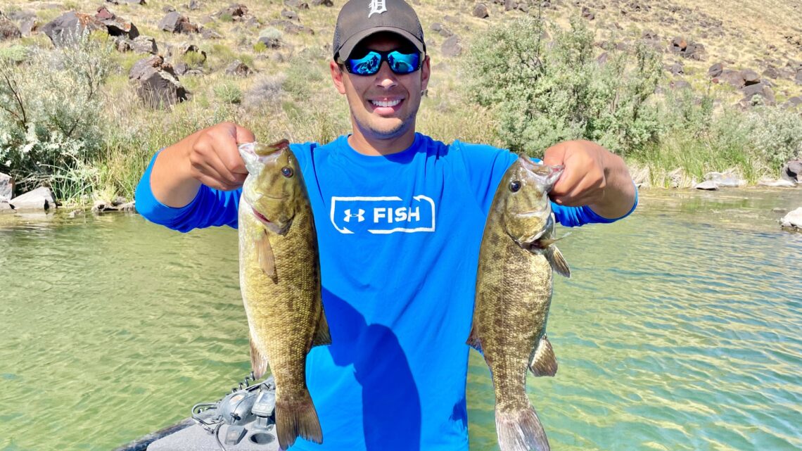 Jordan Rodriguez shows off two big Snake River smallmouth bass.