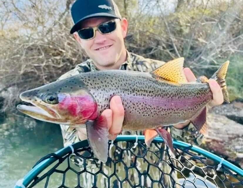 Michael Peterson holds a rainbow trout caught fly-fishing on the Boise River