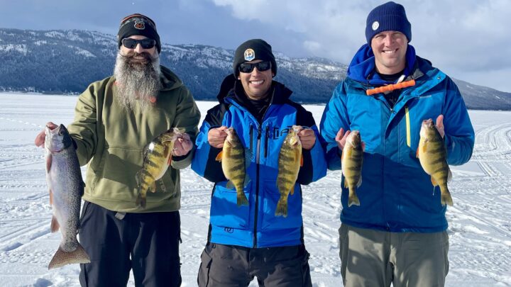 Three anglers show off nice fish caught through the ice at Lake Cascade.