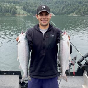 Jordan Rodriguez holding two large Kokanee salmon caught trolling at Anderson Ranch Reservoir.
