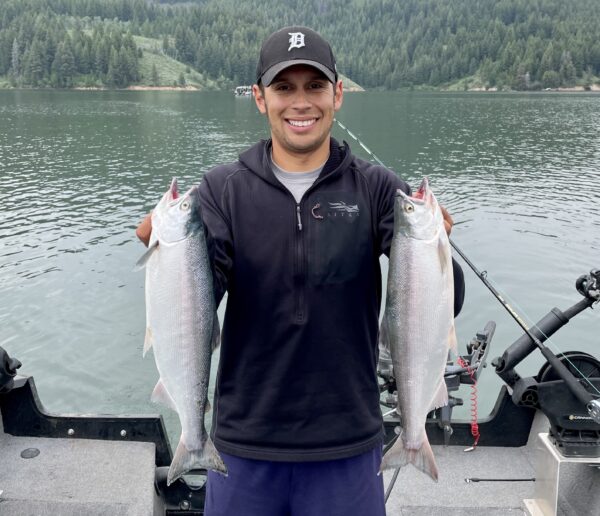 Jordan Rodriguez holding two large Kokanee salmon caught trolling at Anderson Ranch Reservoir.
