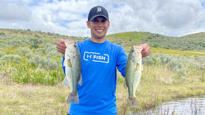 Jordan Rodriguez of Tight Lines 208 holding two largemouth bass.