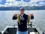 Jordan Rodriguez holding two jumbo perch caught at Lake Cascade