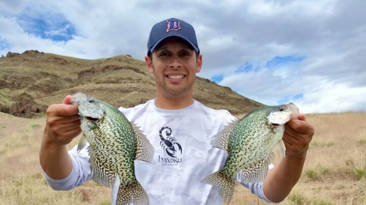 Jordan Rodriguez holding two crappie caught at Owyhee Reservoir in eastern Oregon.
