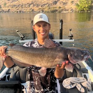 Jordan Rodriguez holding a large channel catfish