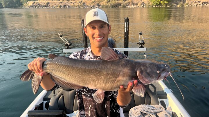 Jordan Rodriguez holding a large channel catfish