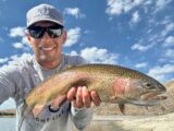 Jordan Rodriguez holding a 23-inch rainbow trout caught in a remote Idaho desert reservoir.