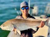 Jordan Rodriguez holding a 40-inch redfish caught off the coast of North Carolina.