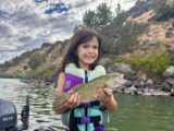 Skye Rodriguez holding a smallmouth bass caught at Massacre Rocks State Park.
