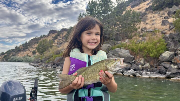 Skye Rodriguez holding a smallmouth bass caught at Massacre Rocks State Park.